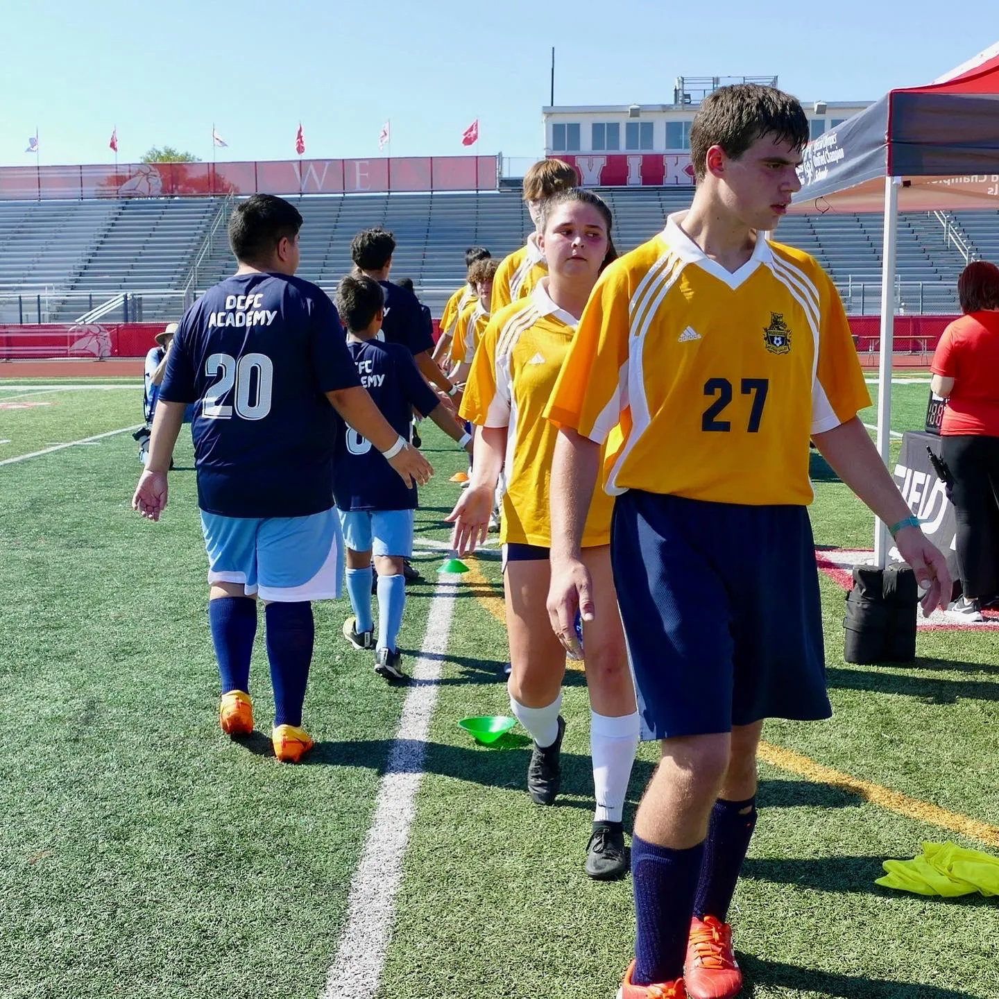 Diverse City FC athletes greeting competitors on the field