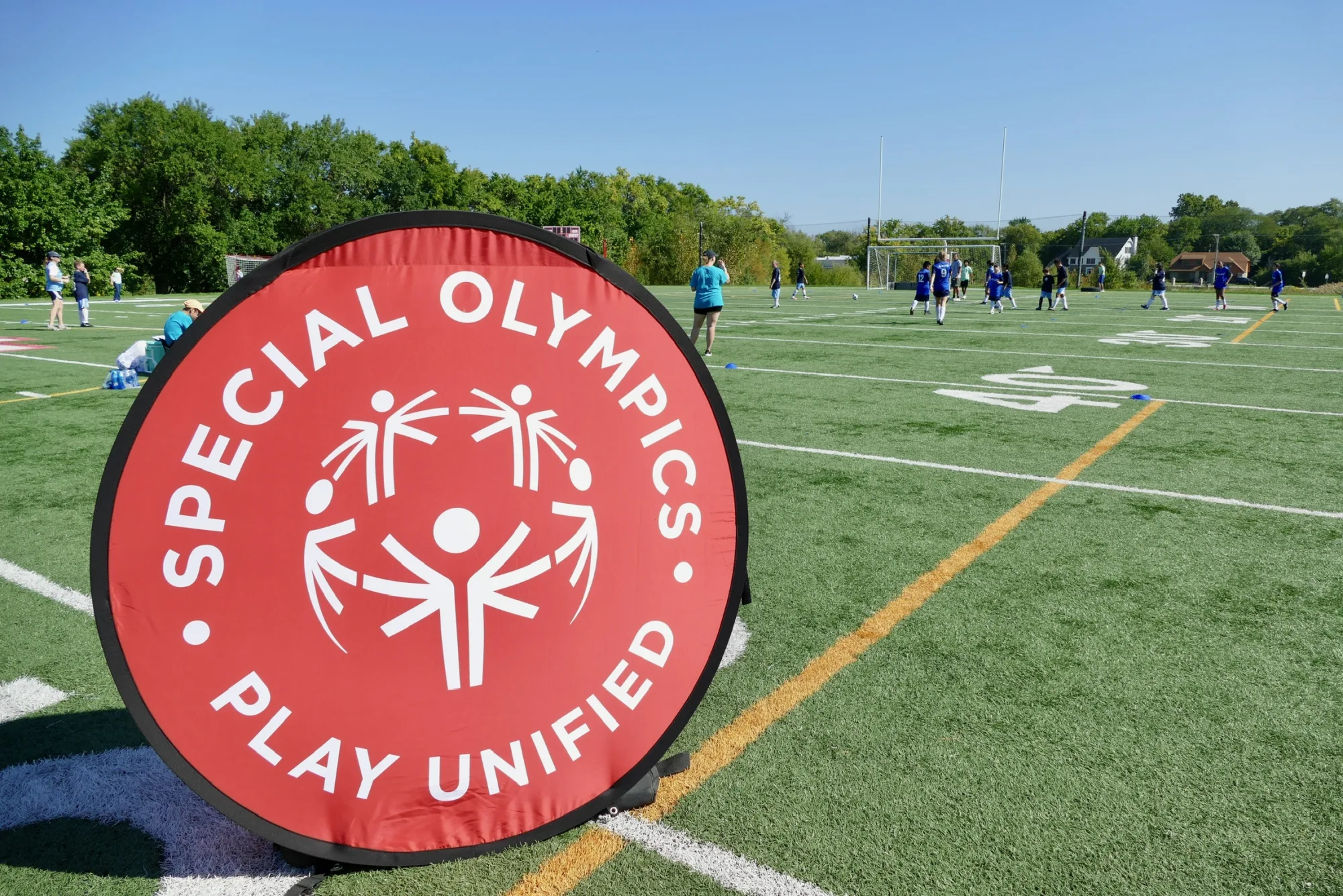 Special Olympics field marker beside an active soccer session