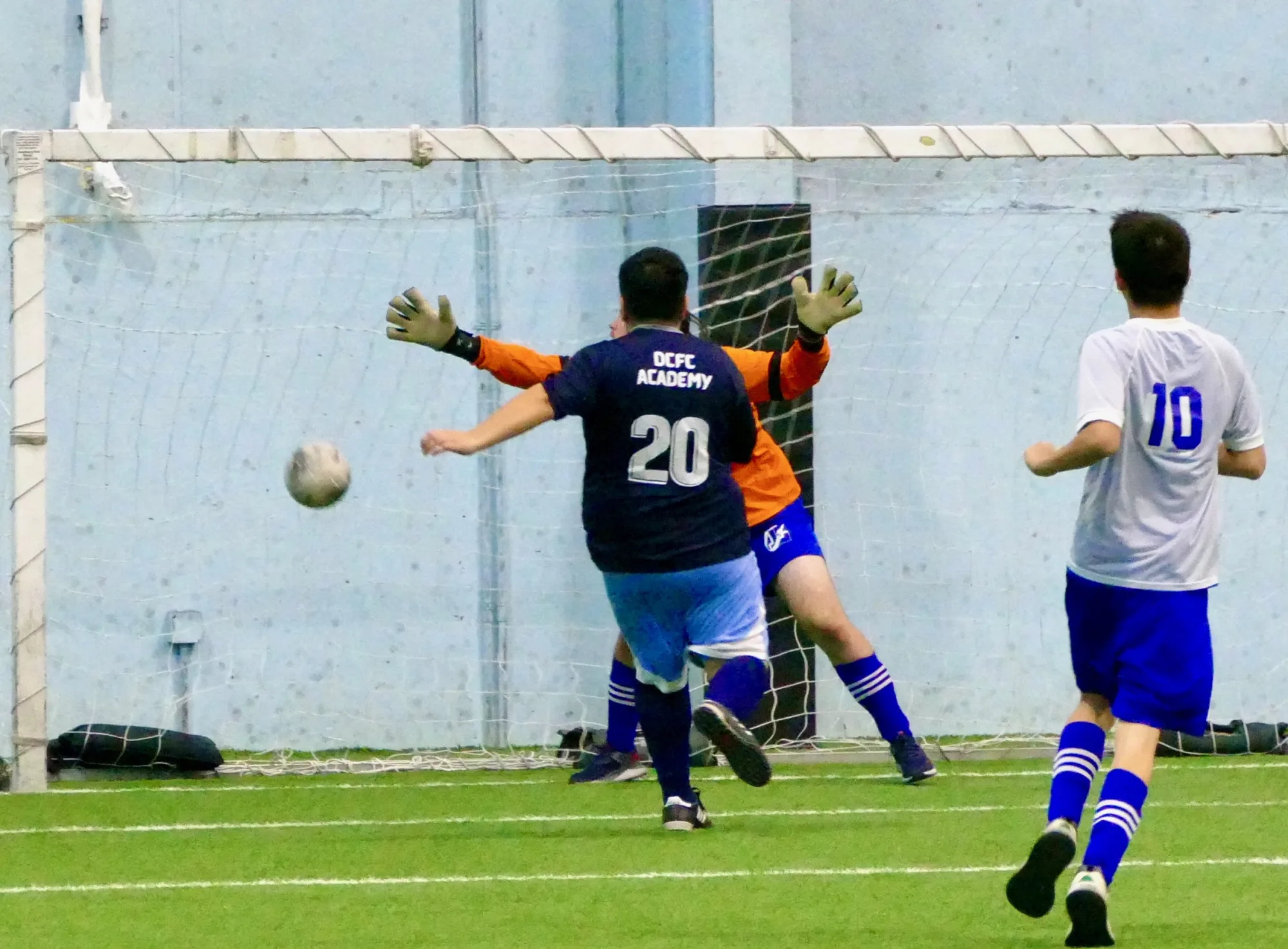 Diverse City FC athlete taking a shot during indoor competition